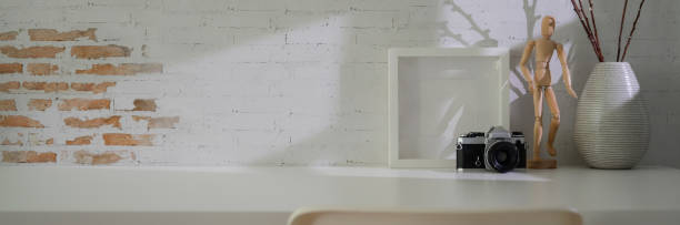 istock Close up view of minimal workspace with camera, decorations and copy space on white table 1217115366