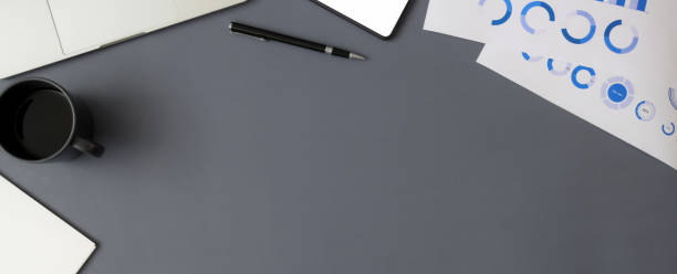 istock Top view of modern workspace with paperwork, digital devices and copy space 1217115370
