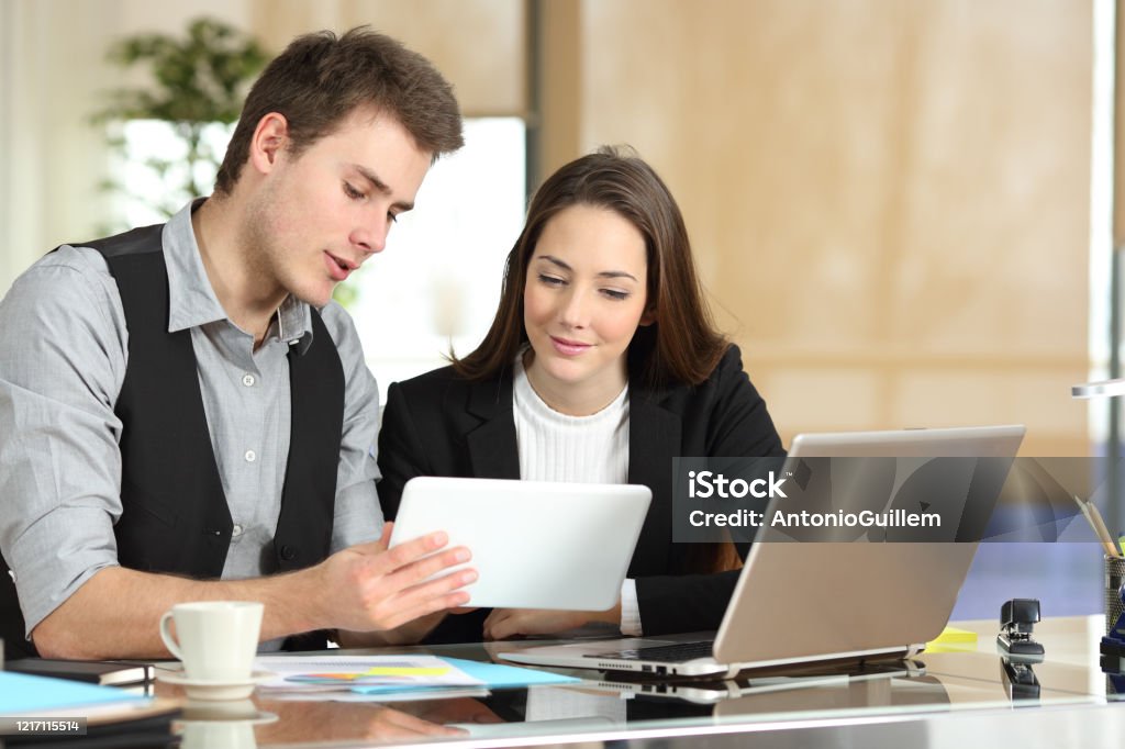 Employee Helping Coworker Showing Tablet Stock Photo - Download Image ...