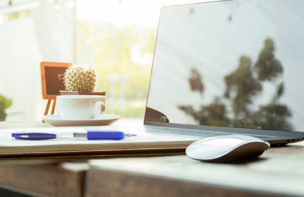 istock Business object pen and laptop and mouse with coffee cup on wooden table. 1217115761