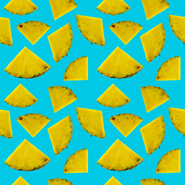 istock Yellow pineapple fruits sliced seamless repeat pattern on blue backgrounds for summer 1217116087