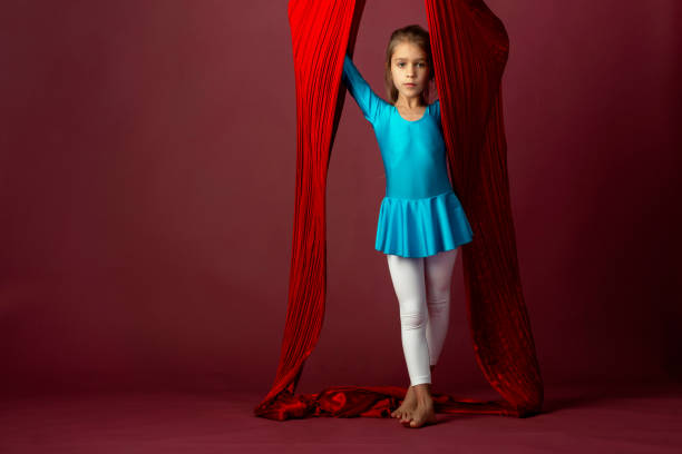 istock Charming little girl in a blue gymnastic suit 1217116880