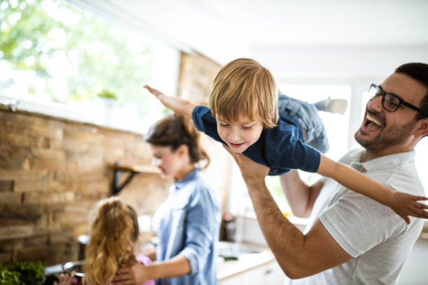 istock Happy boy having fun with his father in the kitchen. 1217117085