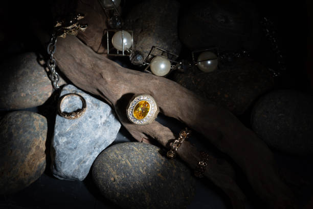 istock Yellow Sapphire and Diamond Ring Resting on a branch With a pearl bracelet decorated Placed on a beautiful patterned stone Along with firing the flash light To emphasize the ring to stand out 1217117401