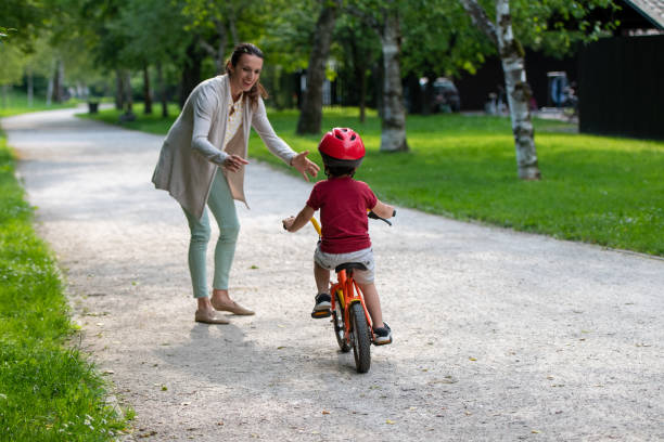 istock Mother teaching her son to ride bicycle 1217118383