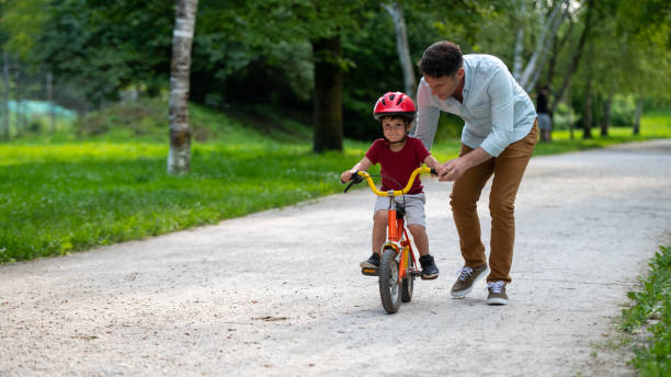 istock Father teaching his son to ride bicycle 1217118397