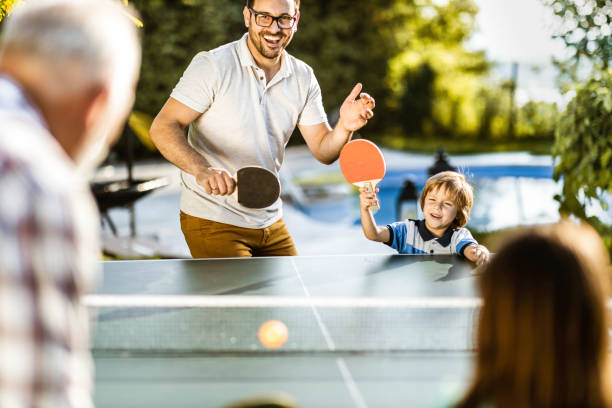 istock Playing table tennis in the backyard! 1217118825