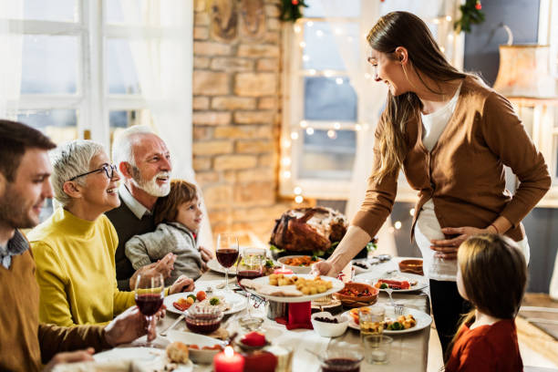 istock Happy multi-generation family having Thanksgiving lunch in dining room. 1217119234