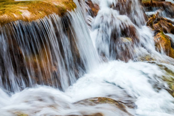 Cascade of water flowing over stones.