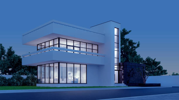 istock Modern house with white plaster with a balcony and a high staircase, in the cold evening light with warm light from the Windows against the background of trees and a white fence 3D stock illustration 1217121922