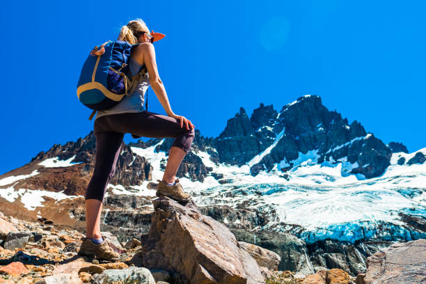 istock Woman hiker stands on the rocks 1217123157