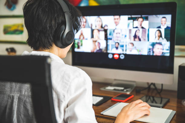 mujer trabajando en casa teniendo una videoconferencia con colegas - mid adult audio fotografías e imágenes de stock