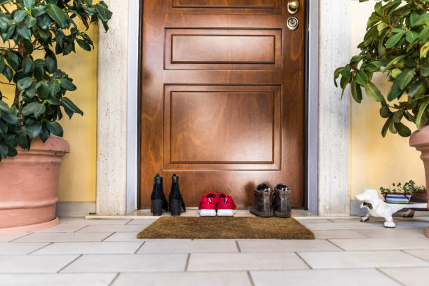 Family Shoes on the porch by the doorstep Family Shoes on the porch by the entrance door doorstep stock pictures, royalty-free photos & images