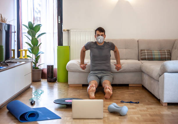 istock man exercising doing workout at home in mask 1217124910