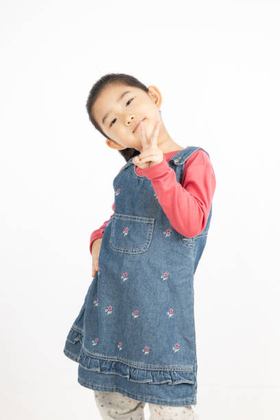 istock Little girl making V shape gesture on White Background 1217125113