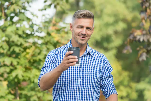 Convenient to use and carry. Happy guy hold takeaway coffee cup. Handsome man enjoy drinking coffee. Coffee to go. Energy drink. Coffee most important meal of day.