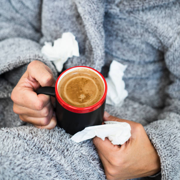 istock ill man warming up with a cup of coffee 1217126452