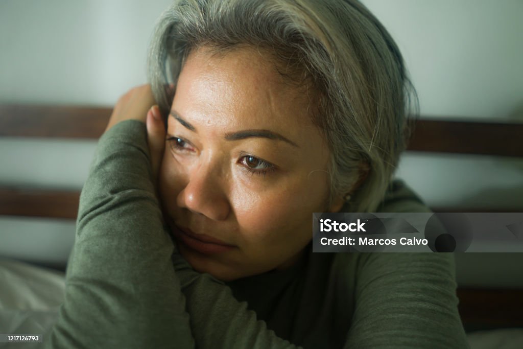 mature lady crisis - attractive middle aged woman with grey hair sad and depressed in bed feeling scared and lonely thinking worried about covid-19 virus pandemic during home lockdown Women Stock Photo