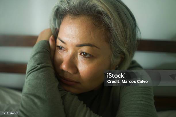 Mature Lady Crisis Attractive Middle Aged Woman With Grey Hair Sad And Depressed In Bed Feeling Scared And Lonely Thinking Worried About Covid19 Virus Pandemic During Home Lockdown Stock Photo - Download Image Now