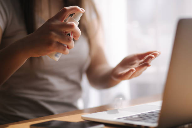 istock Close up woman hands using sanitizer gel dispenser at home. Home isolation, quarantine. Coronavirus concept 1217130186