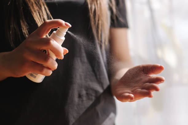 istock Close up woman hands using sanitizer spray, dispenser at home. Home isolation, quarantine. Coronavirus concept 1217130389