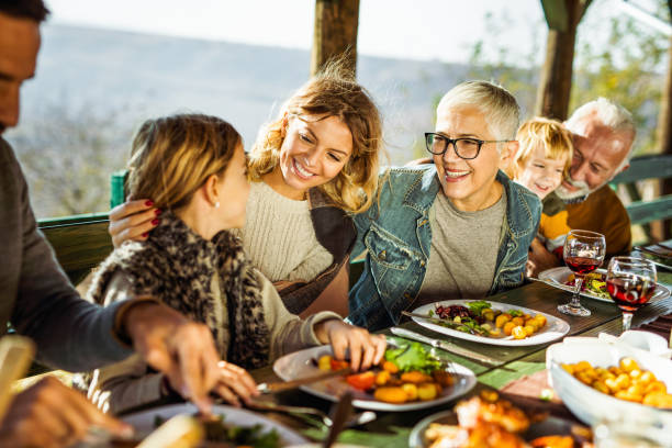 istock Happy extended family talking during lunch on a terrace. 1217132021
