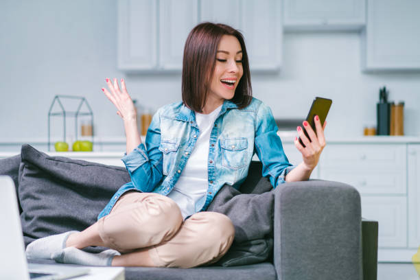 istock Young woman celebrating money win after making bets online at bookmakers website using her laptop 1217132767