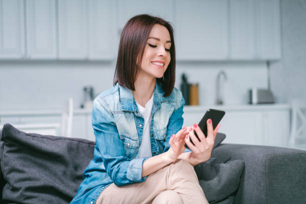 istock Young woman celebrating money win after making bets online at bookmakers website using her laptop 1217132957
