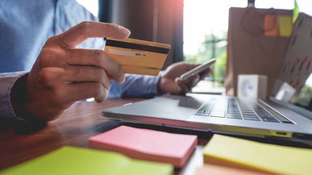 istock Man paying with credit card and entering security code for online shopping making a payment or purchasing goods on the internet with laptop computer, online shopping concept. 1217133127