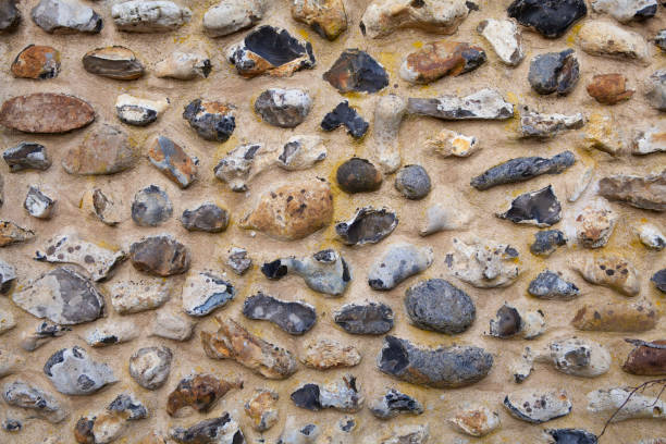 Flint stone wall background Detail of a flint wall texture in Suffolk flint stone stock pictures, royalty-free photos & images