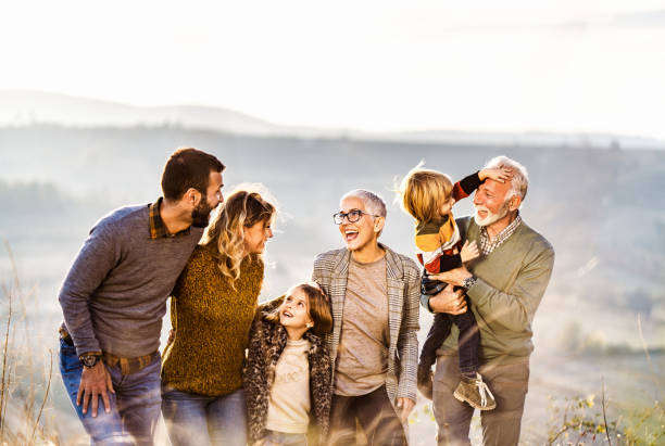 istock Happy extended family communicating while walking in autumn day on a hill. 1217134475