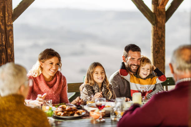 istock Happy multi-generation family communicating while enjoying in their lunch on a balcony. 1217134567