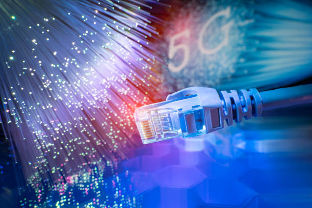 istock Network cable with high tech technology Fiber optical color background 1217137056
