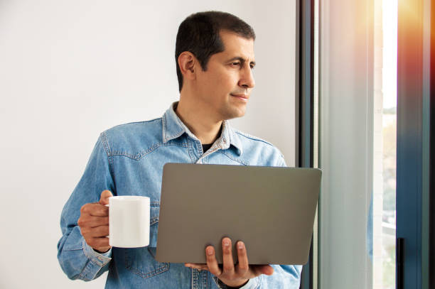 istock Man working online at home on a laptop 1217139498