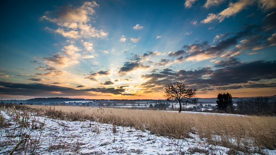 Dawn breaks over fields and farmland under a glorious cloudscape in Berks Counnty, PA in winter