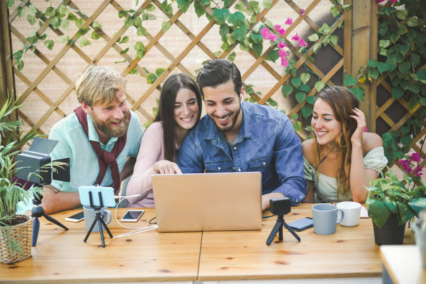 istock Young people streaming online using laptop, smartphone camera and softbox light - Millennial friends having fun with new technology trend - Social media concept - Soft focus on right man face 1217141777