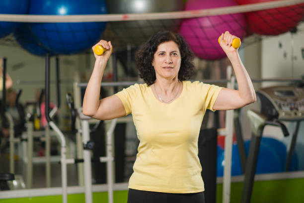istock Mature woman exercising at gym 1217142197