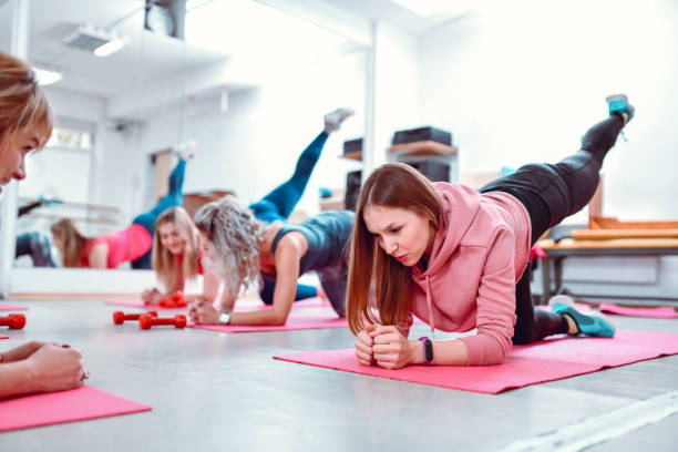 istock Females Doing Plank Leg Raises In Gym 1217142700