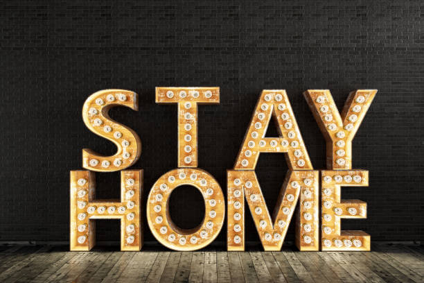 istock Stay Home Sign with Light Bulbs Quarantine Concept 1217142748