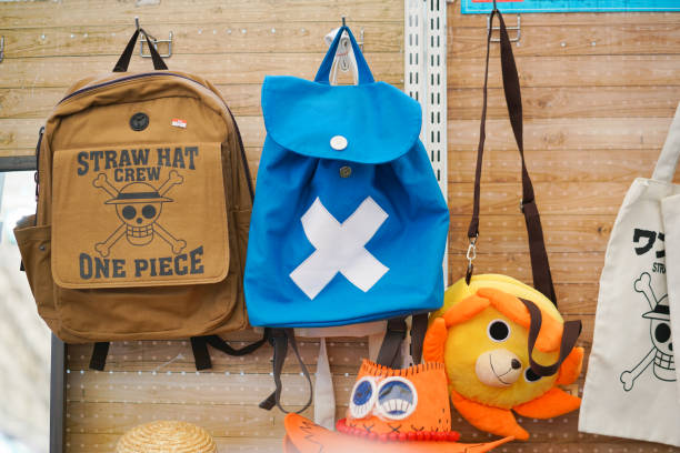 One Piece merchandises BKK, Thailand - Feb 1, 2020 : A photo of One piece merchandises such as backpack hanging on display in the store. One piece of famous & successful manga and anime in Japan & now worldwide. action anime movies stock pictures, royalty-free photos & images