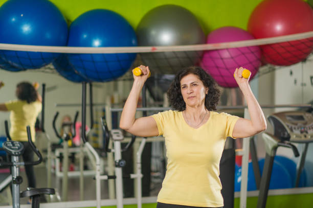 istock Mature woman exercising at gym 1217143843