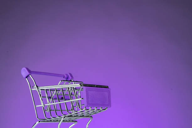 istock Retail shopping cart on purple background 1217147028