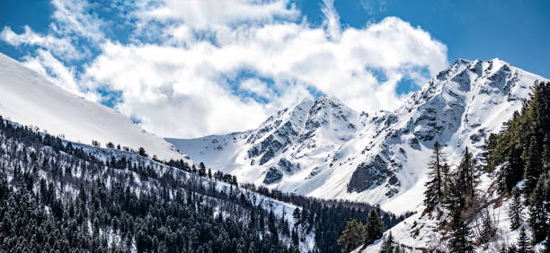 Mountains ridge in Karachay-Cherkess Republic in Russia Panoramic view of mountains ridge in Karachay-Cherkess Republic in Russia at sunny winter day caucasus stock pictures, royalty-free photos & images