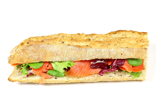 smoked salmon sandwich and salad on a white background