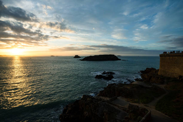 Sunset on the beach of Saint-Malo Sunset on the beach of Saint-Malo stone wall stone wall crag stock pictures, royalty-free photos & images