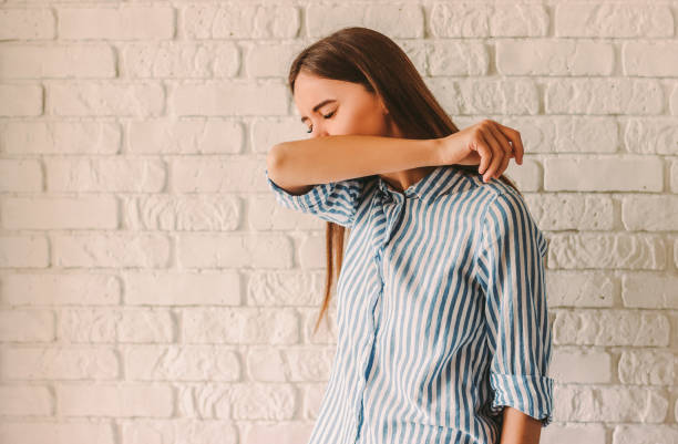 Infected sick woman coughing in arms