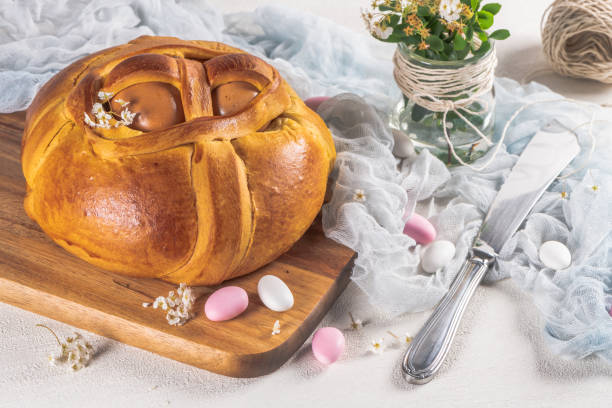 istock Portuguese traditional Easter cake. Folar with eggs on wooden table 1217149283