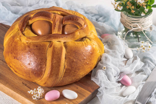 istock Portuguese traditional Easter cake. Folar with eggs on wooden table 1217149518