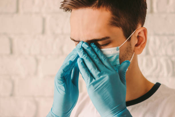 istock Sick man in medical face mask and protective gloves 1217150561