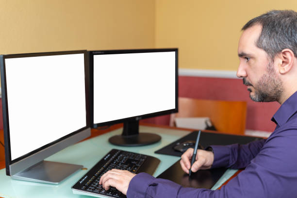 istock man teleworking in house with two screens 1217150741